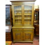 AN OAK ARTS & CRAFTS BOOKCASE TOP SIDEBOARD having an inverted step crown over twin leaded glazed