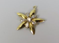 A DIAMOND STAR SHAPED PENDANT in believed 18ct yellow gold (unmarked), 1.6gms