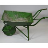 A GREEN PAINTED METAL VINTAGE WHEELBARROW with rubber tyre wheel