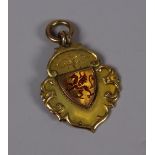 A 9CT GOLD RUGBY UNION PENDANT for the Mallett Cup, 1937 and having an enamel Welsh dragon crest