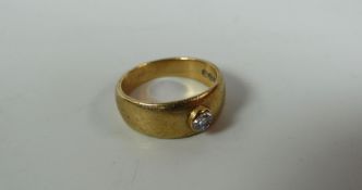 A 9CT YELLOW GOLD & DIAMOND BAND RING, with single raised round-cut diamond, 5.8gms