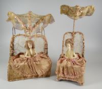 A PAIR OF EARLY TWENTIETH CENTURY DOLL TABLE-LAMPS both 'sat up in bed' with silk bed-clothes and