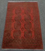 WASHED RED AFGAN DOUBLE KNOT RUG with traditional Bukhari design, 123 x 179cms