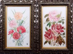 A PAIR OF EARLY TWENTIETH CENTURY PAINTED PORCELAIN PANELS of roses and flowers, in scroll-work