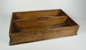 A RUSTIC TWIN COMPARTMENT CUTLERY TRAY with loop centre handle, 32cms long