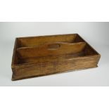 A RUSTIC TWIN COMPARTMENT CUTLERY TRAY with loop centre handle, 32cms long