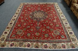 A LARGE RED GROUND TABRIZ CARPET with unique all over design, 276 x 360cms