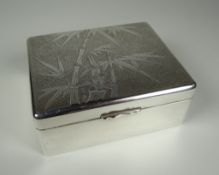 A HONG KONG SILVER CIGARETTE BOX the lid with bamboo decoration to a textured surround, Tackhing