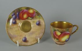 A ROYAL WORCESTER FRUIT DECORATED MINIATURE CUP & SAUCER the saucer signed by Freeman Provenance: