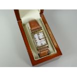 A 'CLOGAU' AUTOMATIC WRIST WATCH with original case and having 9ct yellow gold lugs, tan leather