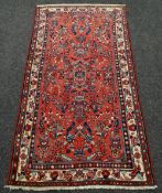 RED GROUND PERSIAN HAMERDAN VILLAGE RUG with all over design, 107 x 208cms
