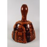 AN INTERESTING SLIPWARE BELL-SHAPED DECANTER with unusual applied symbols including skull and