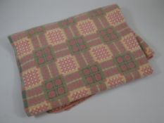 A VINTAGE WOOL WELSH BLANKET typically patterned in pink and green geometric check (BBC Bargain Hun