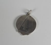 A CIRCULAR SILVER LOCKET with machine turned Art Deco style decoration (BBC Bargain Hunt)