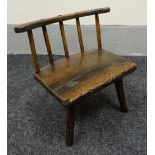 CHILD'S STICK BACK CHAIR in elm, circa 1800, on three feet and with shaped rail and five