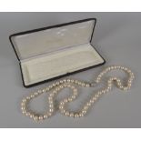 SINGLE-STRAND PEARL NECKLACE having 18ct white gold diamond set globular clasp