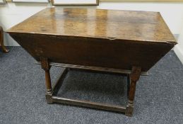 AN EARLY NINETEENTH CENTURY OAK DOUGH BIN with hinged top & raised over tapering supports & low