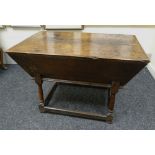 AN EARLY NINETEENTH CENTURY OAK DOUGH BIN with hinged top & raised over tapering supports & low