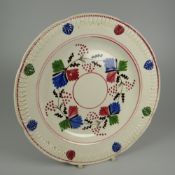 A NINETEENTH CENTURY DILLWYN & CO SWANSEA POTTERY PLATE with moulded border and three-colour sponged