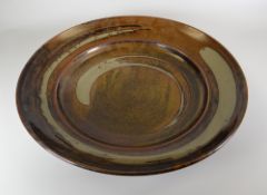 A LARGE STUDIO POTTERY DISH label verso for Andrew Crouch of Ludlow, 44cms high