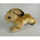 A STEIFF SOFT-TOY RABBIT in leaping pose and with glass eyes, label and stud to ear, 22cms long