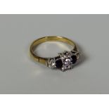 A DIAMOND & SAPPHIRE RING in 9ct yellow gold, 2.1gms