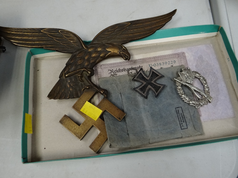 A parcel of Third Reich memorabilia, a bronze eagle on swastika, iron cross etc