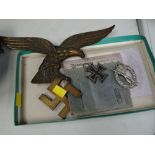 A parcel of Third Reich memorabilia, a bronze eagle on swastika, iron cross etc