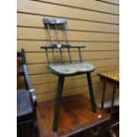A three-legged elm seat spindle backed child's chair