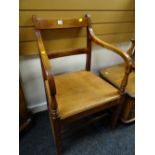 An antique early twentieth century mahogany railback hall armchair