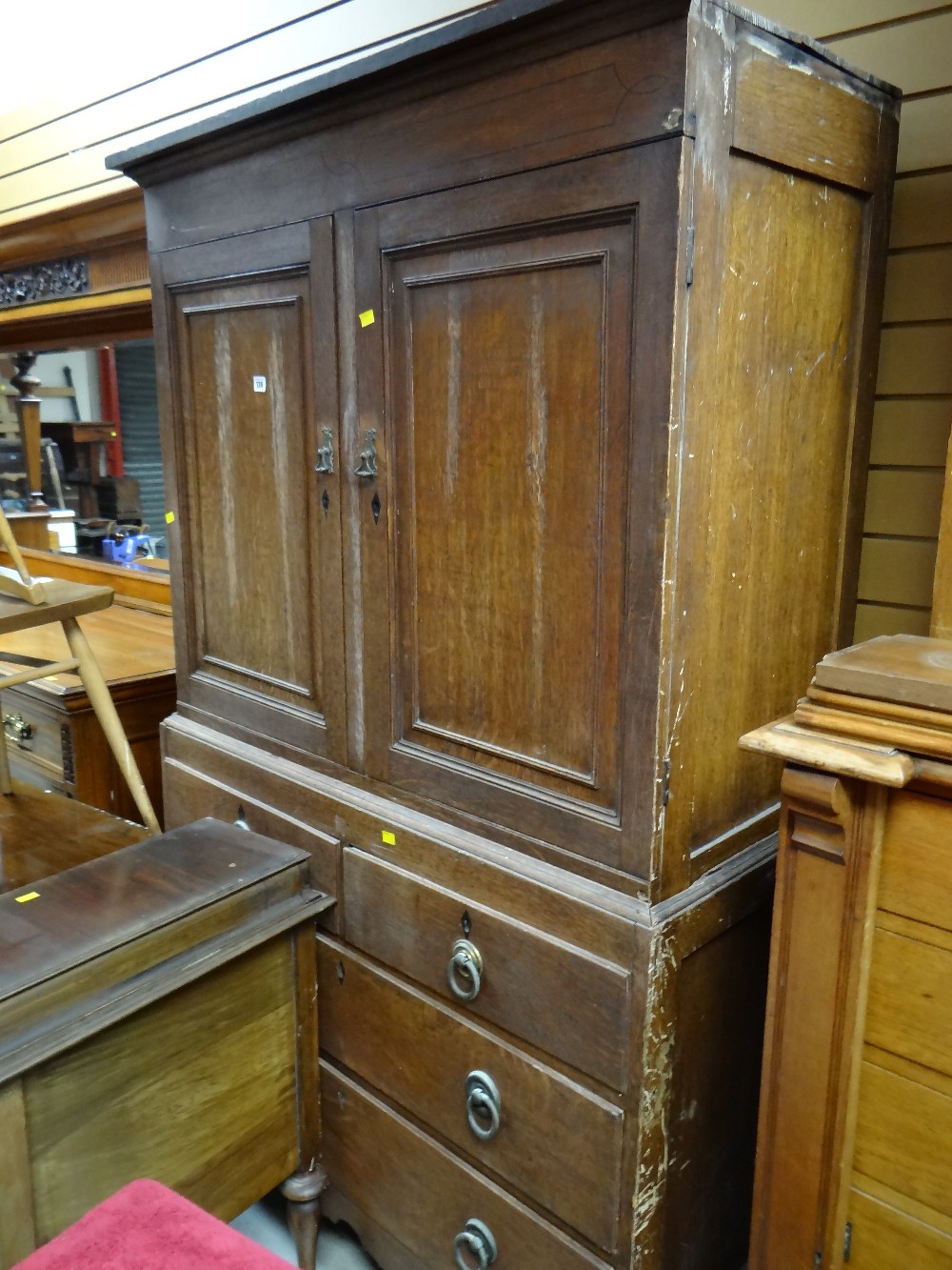 A nineteenth century oak press cupboard with a base of two long & two short drawers