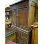 A nineteenth century oak press cupboard with a base of two long & two short drawers