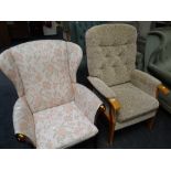A modern upholstered cushioned high back armchair together with another similar