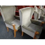 A pair of modern pale green velour upholstered wood framed wingback armchairs