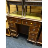 A neat reproduction mahogany leather tool topped desk of small proportions with bank of drawers to