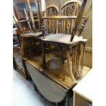 An antique oak gateleg dining table & four wheel back chairs