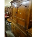 A nineteenth century Welsh oak linen cupboard with a base of two long & two short drawers
