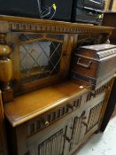 A glazed linen-fold Priory-style buffet sideboard