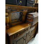 A glazed linen-fold Priory-style buffet sideboard