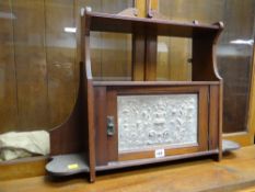 A vintage wall hanging smoker's cabinet with carved door