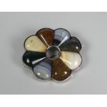 A SILVER & AGATE BROOCH in circular fanned form with hollow circular centre, 4.75cms diam (BBC