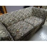 A two-seater floral upholstered Chesterfield-style foldout bed settee