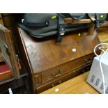 A vintage three-drawer slope fronted bureau