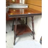 An antique two-tier mahogany square based coffee table