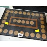 A wall mounting display set of early twentieth century pennies from Queen Victoria to Elizabeth II