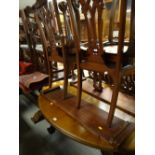 An oval extending mahogany dining table (two leaves) & four Chippendale-style carved back chairs