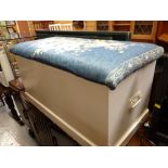 A white painted pine cushion-top blanket-chest