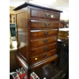 A six-drawer mahogany music cabinet