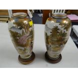 A pair of Japanese Satsuma ware decorated vases on stands