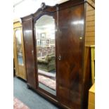 A large early twentieth century mahogany two-door wardrobe with centre mirror